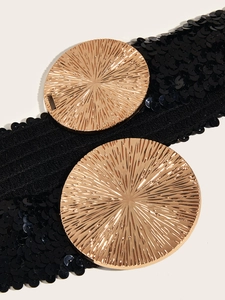 Close-up of black sequin elastic waist belt featuring two textured gold round buckles