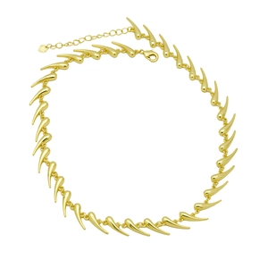 Macro shot of gold-plated spiked thorn chain featuring lobster clasp and extension chain