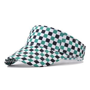 Detail of green and black checkered canvas sun hat with wide brim and white piping