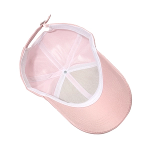Internal view of pink baseball cap showing sweatband and adjustable metal buckle