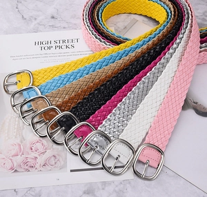 Detailed view of colorful woven PU leather belts with silver buckles in various bright shades
