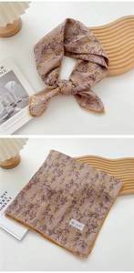 Detail of floral cotton linen square scarf with yellow lace trim on wooden tray