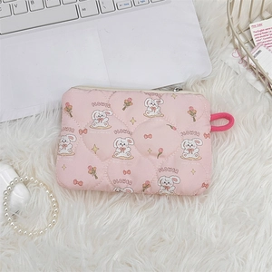 Detailed view of pink quilted fabric mini pouch with cute rabbit and flower patterns