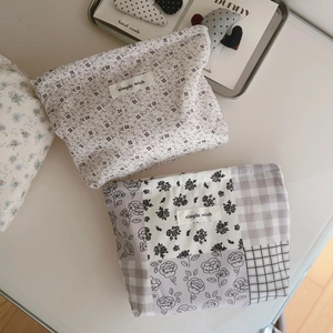 Detailed view of floral cotton makeup bags with simple wish labels and retro prints