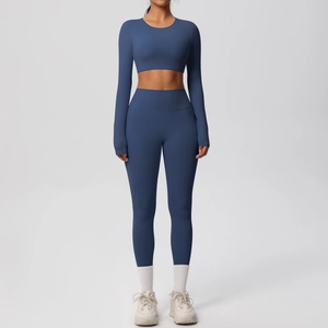 Detail of high-waisted leggings and long sleeve crop top yoga set in matte misty blue