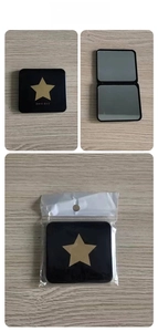 Detail view of foldable black pocket mirror with gold star and OPP packaging