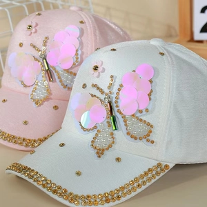 Detail of butterfly sequin and faux pearl embroidery with rhinestones on baseball cap