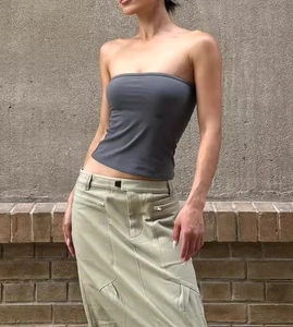 Detailed view of dark grey strapless tube top paired with khaki utility cargo midi skirt