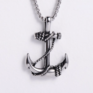 Close-up of silver stainless steel anchor pendant with rope detail on a box chain