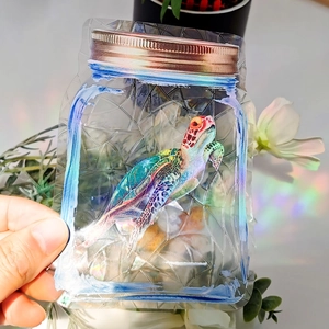 Close-up of rainbow prism window cling in mason jar shape with sea turtle design