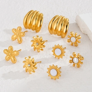Detailed set of five gold floral and textured stud earrings on a minimalist white backdrop