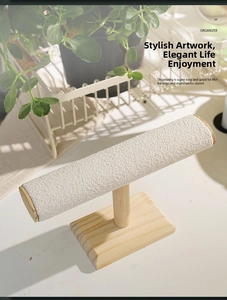 Close-up of wooden T-bar jewelry display stand with beige velvet rod for bracelets