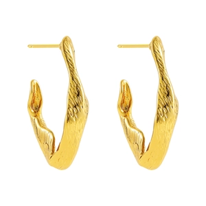 Macro detail of gold-plated C-shaped earrings with hammered texture and organic shape