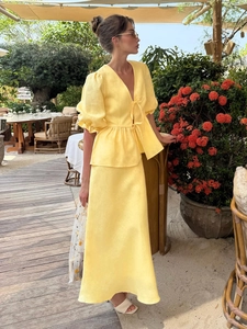Detail of yellow linen v-neck tie-front top with ruffled sleeves and matching maxi skirt