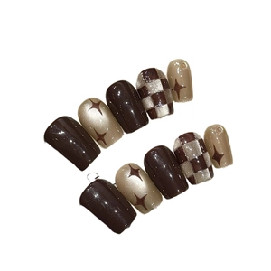 Brown checkerboard and champagne gold press-on nails with star motifs and glossy finish