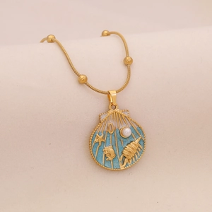 Golden sea shell necklace with blue enamel, starfish, and pearl pendant jewelry