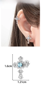 Macro detail of silver cross cartilage stud earring with light blue square center stone