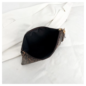 Detailed top view of leopard print clutch bag showing interior space and gold zipper