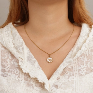 Gold PVD coated stainless steel zodiac necklace with horse pendant and white inlay