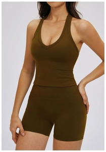 Detail of olive green ribbed workout set featuring a halter neck sports bra and shorts