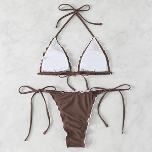 Macro view of brown halter bikini with removable round pads and white scalloped edges