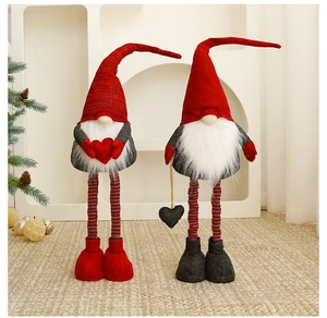 Detail of two Christmas gnomes with long striped legs and heart accents in a cozy setting