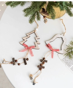 Detail of wooden Christmas tree and bell ornaments with red plaid bows and small bells