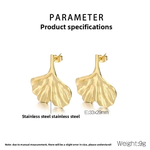 Detail view of gold ginkgo leaf stainless steel earrings with 33x29mm size specifications