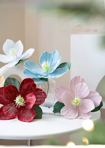 Detail of velvet artificial Christmas flowers with sparkling silver glitter for holiday decor