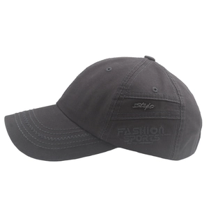 Detailed side view of washed cotton baseball cap with embroidered logo and curved visor