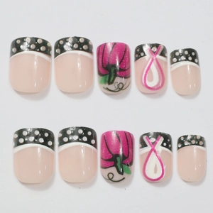 Short square press-on nails with rose pink ribbons and black French polka dot designs