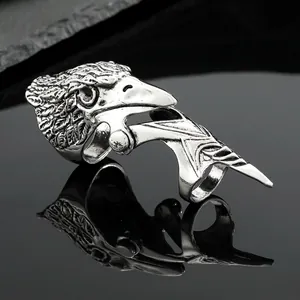 Macro shot of vintage punk eagle head finger ring with silver metal texture and details