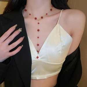 Vintage Y-shaped gold plated necklace with red agate beads shown on a model