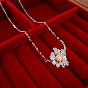 Macro detail of daisy flower pendant with silver chain and zircon-studded petals