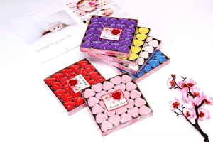 Detailed top view of 50pcs heart-shaped tealight candles in vibrant multiple colors