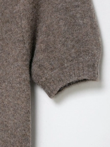Close-up of ribbed cuffs and fuzzy wool texture on a mocha brown knit mini dress