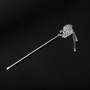 Detail of silver peacock hollow hair pin with mesh filigree flower and dangling tassels