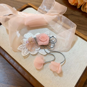 Detail of pink organza rose choker with embroidery leaf and delicate beaded charms