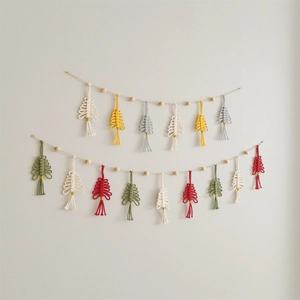 Detail of handmade macrame Christmas tree garland with colorful cotton rope and wooden beads