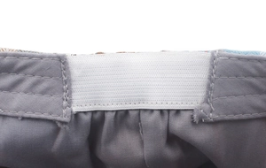 Detail of adjustable elastic inner band and gray lining on the plaid beret hat