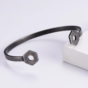 Macro detail of industrial hex nut cuff bracelet with a vintage oxidized finish