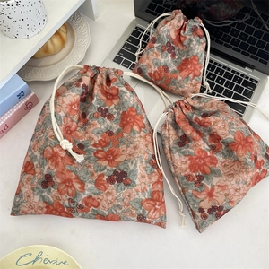Detailed set of floral drawstring storage bags in three sizes for cosmetics and travel