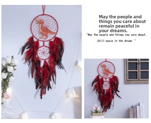 Detail of Nordic dinosaur dreamcatcher with dark red feathers and string lights decor