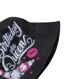 Detail of black bucket hat with Birthday QUEEN text, pink lips, and rhinestone prints