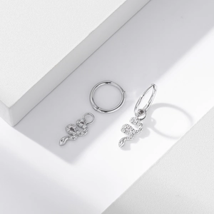Detailed macro view of S925 silver snake earrings with pavé set cubic zirconia stones