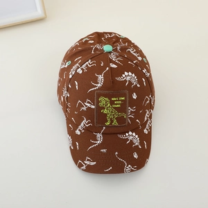 Detail of kids baseball cap with white dinosaur skeleton prints and green dinosaur patch