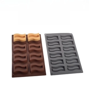 Detailed view of brown and grey wave-shaped silicone molds for chocolate or cake making