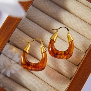 Vintage Maillard resin gold-plated U-shaped earrings displayed in a luxury jewelry box