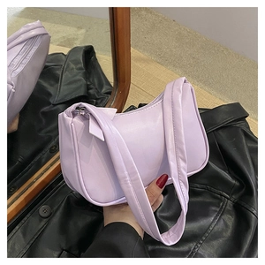 Close-up of lilac purple crescent underarm bag with minimalist wide strap design