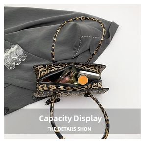 Top view of leopard print handbag showing internal capacity for phone and cosmetics